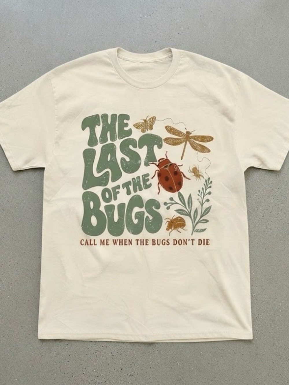Gildan Cream Graphic Tee with Green Retro Text and Multicolor Bug Art